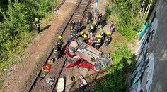 Po srážce aut v Praze jedno spadlo do kolejiště. Seniorku museli vyprostit hasiči
