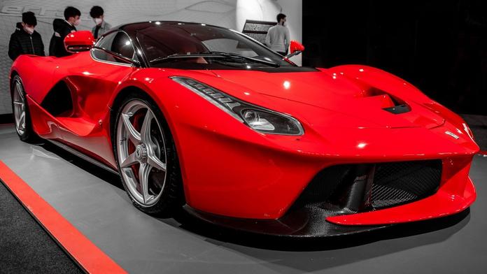 Aktivisté se na výstavě aut přilepili ke sporťákům Ferrari a polili je barvou