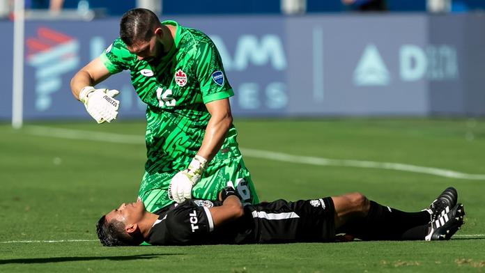 Gólman Kanady Maxime Crépeau se sklání nad rozhodčím, který zkolaboval