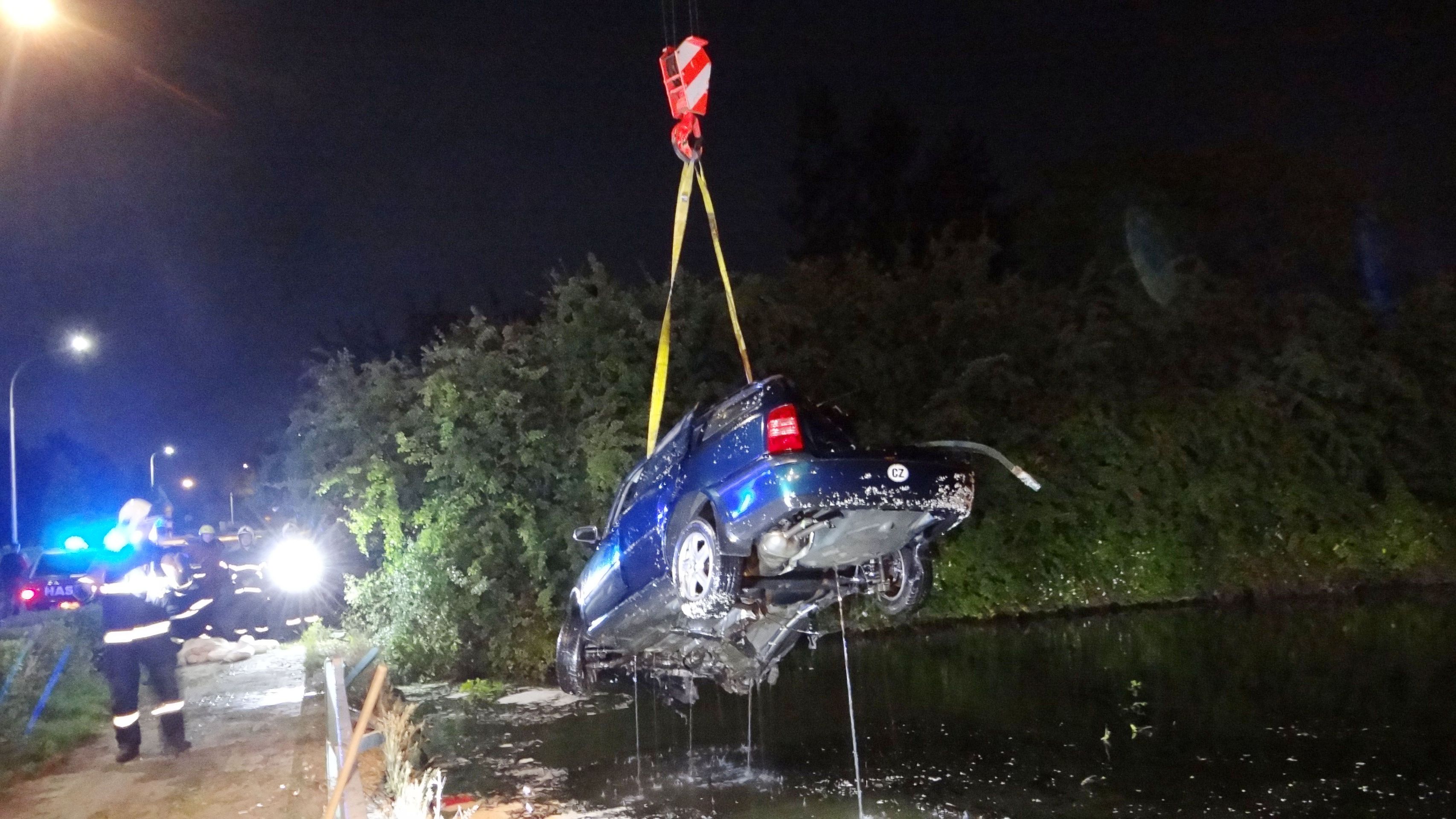 Zničené auto vytáhli z vody hasiči jeřábem - GALERIE: Opilý řidič vjel do rybníka (6/8)