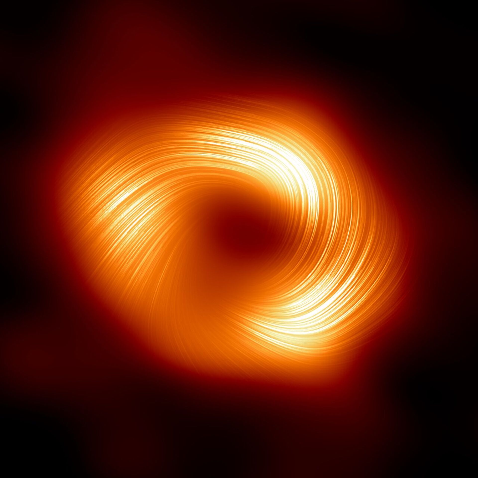 Silná a organizovaná magnetická pole spirálovitě se šířící od okraje supermasivní černé díry Sagittarius A* - Supermasivní černá díra Sagittarius A* (3/3)